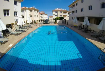 a large blue swimming pool in a courtyard with buildings at 3 bed, Kapparis, Thea - 3C in Paralimni