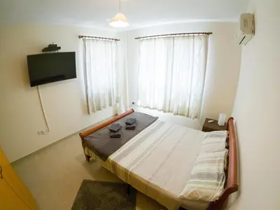 a bedroom with a bed and a television in it at 3 bed, Kapparis, Thea - 3C in Paralimni