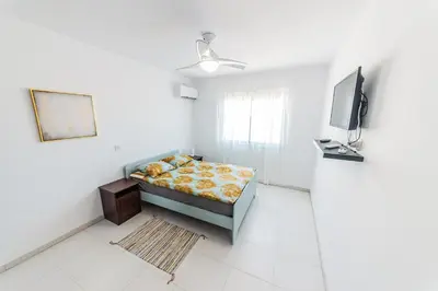 a bedroom with a bed and a television in it at 2 bed, Kapparis, Trinidad - 2A in Paralimni