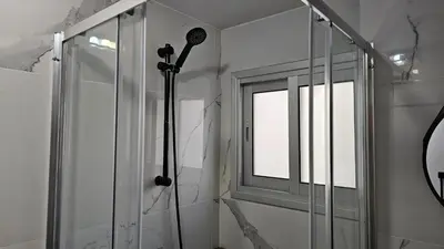 a shower in a bathroom with a window at STAY Sky Apartment in Limassol