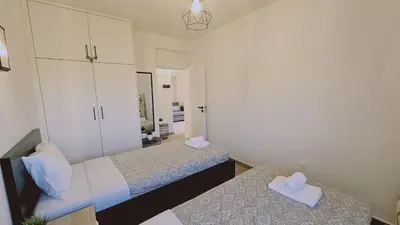 a bedroom with two beds and a mirror at STAY Sky Apartment in Limassol