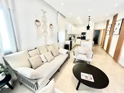 a living room with a white couch and a table at Crystal-Blue-Villa Protaras in Protaras
