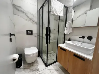 a bathroom with a shower and a toilet and a sink at Crystal-Blue-Villa Protaras in Protaras