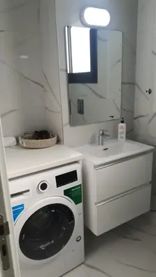 a bathroom with a washing machine and a sink at Hypnos Residence in Nicosia