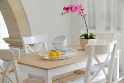 a dining room table with two lemons on it at Ayios Elias Pearl in Protaras