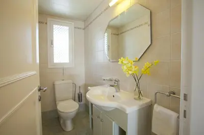 a bathroom with a sink and a toilet and a mirror at Ayios Elias Pearl in Protaras