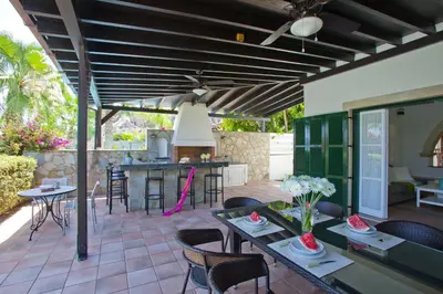 a patio with tables and chairs and a kitchen at Ayios Elias Pearl in Protaras