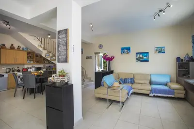 a living room with a couch and a kitchen at Villa Elias in Ayia Napa