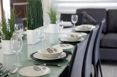 a dining room table with plates and wine glasses at Theodora in Protaras