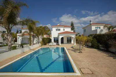 a large swimming pool in front of a house at Ayia Thekla Sea Front in Ayia Napa