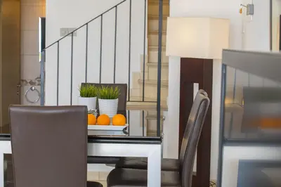 a dining room with a table with oranges on it at Ayia Thekla Sea Front in Ayia Napa