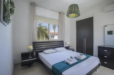 a bedroom with a large bed and a window at Protaras Seaside Villa Michelle 10 in Protaras