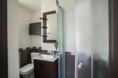 a bathroom with a toilet and a sink and a mirror at Protaras Seaside Villa Michelle 10 in Protaras