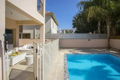 a swimming pool in the backyard of a house at Protaras Seaside Villa Michelle 10 in Protaras