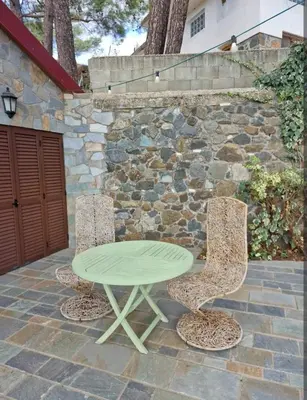 a green table and two chairs on a patio at Butterfly Home in Platres