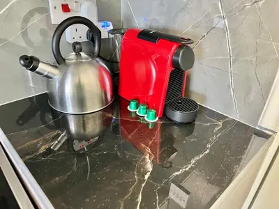 a kitchen counter with a tea kettle and a mixer at Enaerios SeaView Studio in Limassol