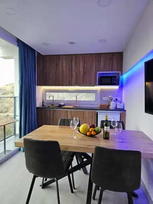 a kitchen with a wooden table with fruit on it at THE CLIFF ALONA in Alona