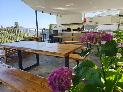 a restaurant with wooden tables and purple flowers at THE CLIFF ALONA in Alona