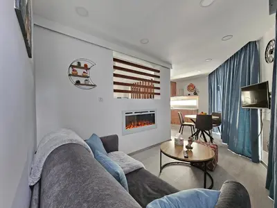 a living room with a couch and a fireplace at THE CLIFF ALONA in Alona