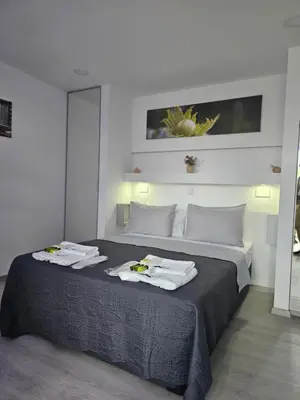 a bedroom with a bed with towels on it at THE CLIFF ALONA in Alona