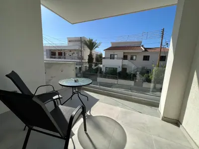 a patio with a table and chairs on a balcony at Prince Boutique Apartment/1BR in Nicosia