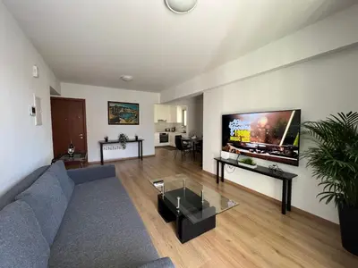 a living room with a couch and a flat screen tv at Prince Boutique Apartment/1BR in Nicosia