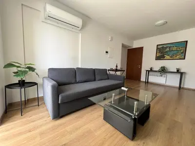 a living room with a couch and a glass table at Prince Boutique Apartment/1BR in Nicosia