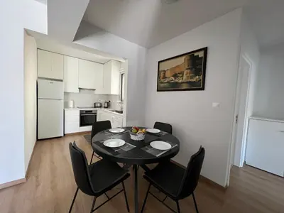 a dining room with a black table and chairs at Prince Boutique Apartment/1BR in Nicosia
