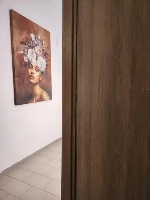 a painting of a woman is on a wall at Luxury Kalipso Beachfront in Limassol
