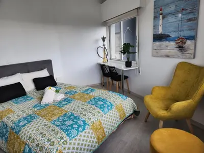 a bedroom with a bed and a chair and a desk at Luxury Kalipso Beachfront in Limassol