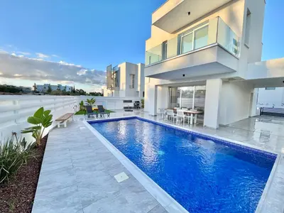 a swimming pool in the backyard of a house at Sol e Mar Villa 2 in Paralimni