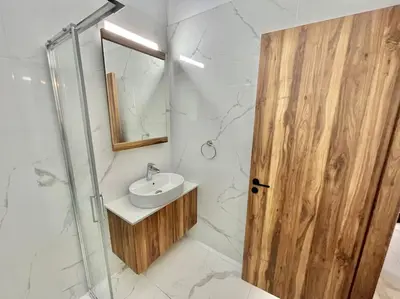 a bathroom with a sink and a glass shower at Sol e Mar Villa 2 in Paralimni