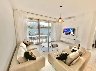 a living room with two couches and a television at Sol e Mar Villa 2 in Paralimni