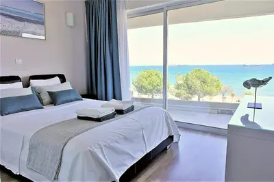 a bedroom with a bed with a view of the ocean at Eden Dream Apartments in Limassol