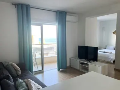 a living room with a couch and a television and a bed at Eden Dream Apartments in Limassol
