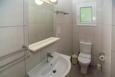 a bathroom with a sink and a toilet and a mirror at Villa Christo in Psematismenos