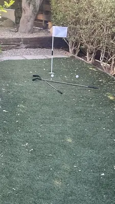 a golf course with a white flag and golf balls at Villa Christo in Psematismenos
