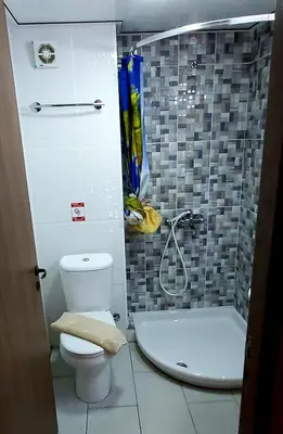 a bathroom with a toilet and a shower and a tub at Lakis Court in Larnaka
