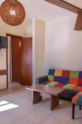 a living room with a couch and a table at Lakis Court in Larnaka
