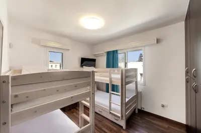 a room with a bunk bed and a window at Accomoteleia Crystal Lagoon Villa in Protaras