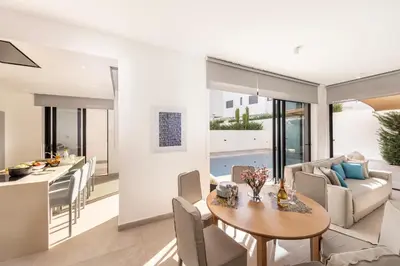 a living room and dining room with a table and chairs at Protaras Periyiali Seaside Villa 33 in Protaras
