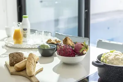 a table with a bowl of food and other foods at Protaras Periyiali Seaside Villa 33 in Protaras
