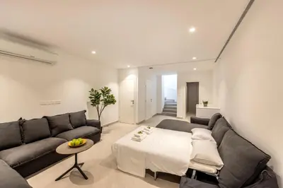 a living room with a couch and a table at Protaras Periyiali Seaside Villa 33 in Protaras
