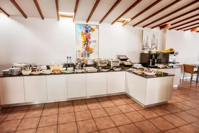 a kitchen with white cabinets and a counter top at Paul Marie Hotel Apartments in Ayia Napa