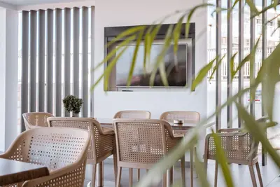 a row of chairs and a table in a restaurant at Paul Marie Hotel Apartments in Ayia Napa