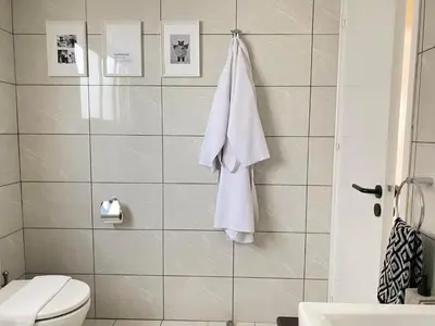 a bathroom with a white towel hanging on a wall at Central Boutique Twenty One in Nicosia