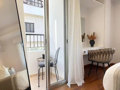 a bedroom with a mirror and a table with a chair at Central Boutique Twenty One in Nicosia
