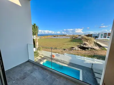 a view from the balcony of a house with a swimming pool at Alasia Villa ll Kapparis in Paralimni