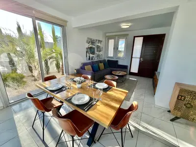 a dining room with a table and chairs at Alasia Villa ll Kapparis in Paralimni