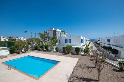 a view of a swimming pool in front of a building at The Good Times Apartment in Protaras